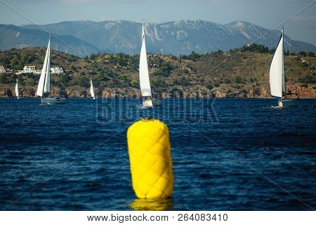 Homestretch for Yachts. Sailboats participate in sailing regatta.