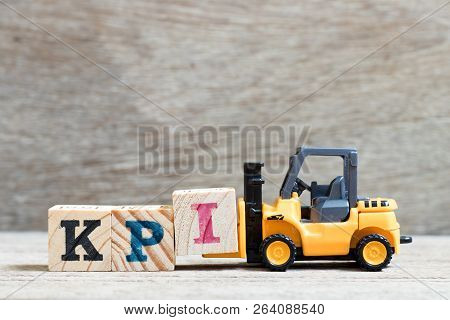 Toy Forklift Hold Lette Block I To Complete Word Kpi (abbreviation Of Key Performance Indicator) On 