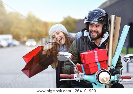 Portrait of happy couple with shopping bags after shopping in city