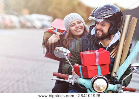 Portrait of happy couple with shopping bags after shopping in city