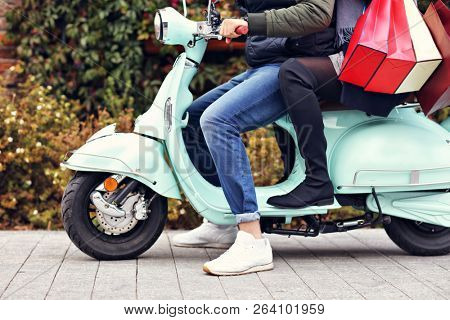 Portrait of happy couple with shopping bags after shopping in city