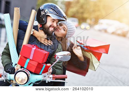 Portrait of happy couple with shopping bags after shopping in city