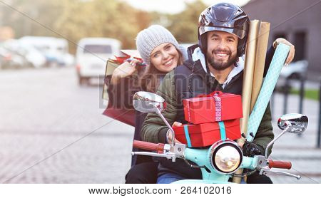 Portrait of happy couple with shopping bags after shopping in city