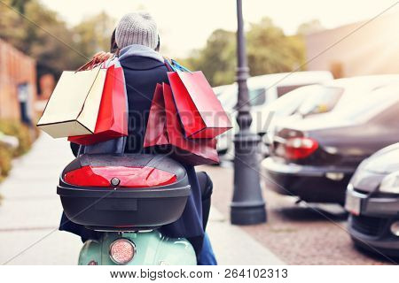 Portrait of happy couple with shopping bags after shopping in city