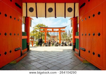 Kyoto, Japan, May 19, 2018 : Big Red Wooden Gates And Torii Pole Of Fushimi Inari Shrine With Crowd 