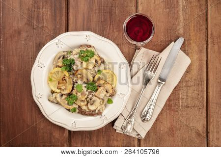 Overhead Photo Of Scallopine Di Vitello, Veal Scallopini, With A Mushroom Sauce, Lemons, And Parsley