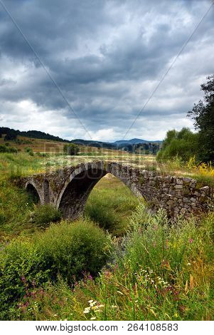 Old Roman Bridge In The Rodopi Mountain Located In Bulgaria