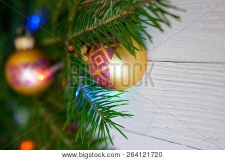 New Year Tree, Decorated With Beautiful Balls And Colorful Lights, On A Light Background. Congratula