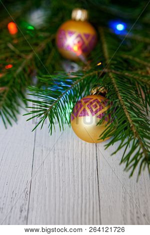 Christmas Tree, Decorated With Golden Balls And Colorful Lights, On A Light Background. Congratulati