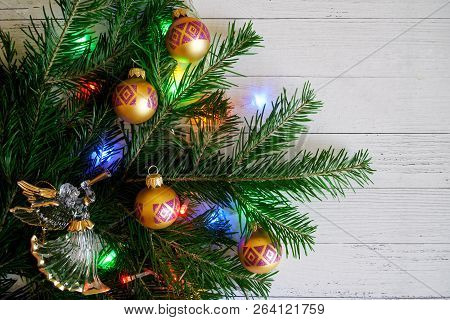Composition With A Christmas Tree, An Angel, Beautiful Balls And Colorful Lights, On A Light Backgro