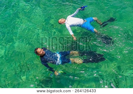 Labuan,malaysia-sept 22,2018:tourists Snorkeling In Deep Blue Sea In The Tropical Lagoon Of Rusukan 