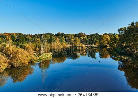 Trees On The Banks Of The Lusatian Neisse During Autumn On The Border Between Poland And Germany