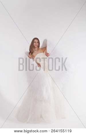 Girl In White Dress With Angel Wings On White Background. Angel-woman