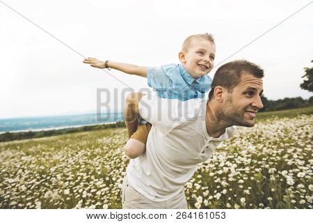 Father Spending Time With Son During The Sunset.