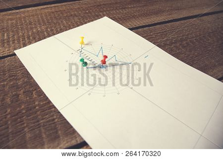 Workplace On Wooden Table With Graph Papers And Supplies