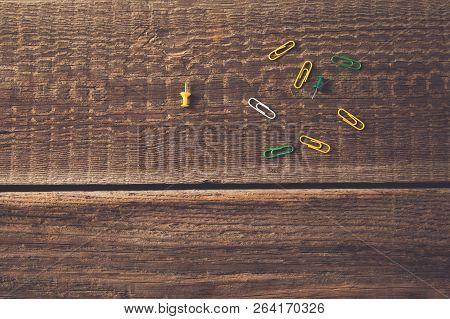 Colorful Paperclips On Vintage Wooden Table Background