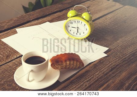 Cup Of Coffee And Clock On Document Paper