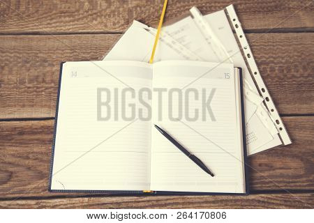 Pen And Notepad On The Wooden Desk