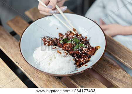Close Up Of Chinese Food. Tsos Chicken With Rice In White Plate On The Table.