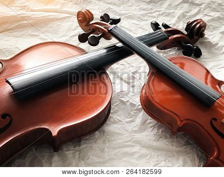 Two Different Size Of Violins Put On Background,warm Light Tone,blurry Light Adesign Background