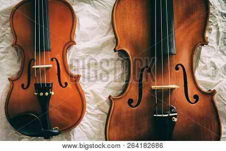 Two Different Size Of Violins Put On Background,warm Light Tone,blurry Light Adesign Background