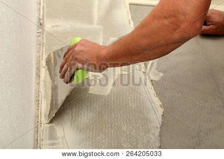 Work On Laying Flooring. Worker Installing New Vinyl Tile Floor.