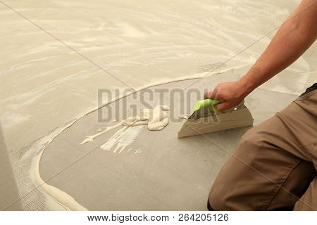 Work On Laying Flooring. Worker Installing New Vinyl Tile Floor.