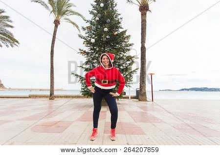 Christmas, Holidays And Humor Concept - Young Happy Woman Have Fun In Christmas Costume At Summer Ne
