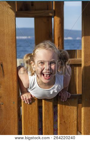 Child Girl Playing In The Playground In Park