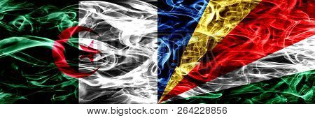 Algeria, Algerian Vs Seychelles, Seychelloise Smoke Flags Placed Side By Side. Concept And Idea Flag