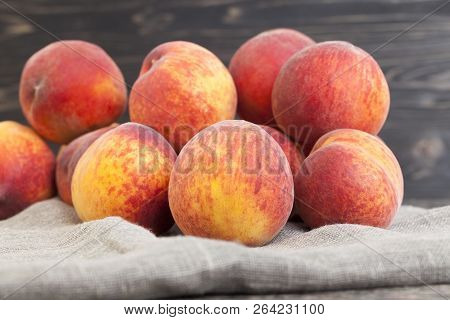 A Bunch Of Ripe Yellow-orange Peach Fruits On A Linen Napkin, Closeup