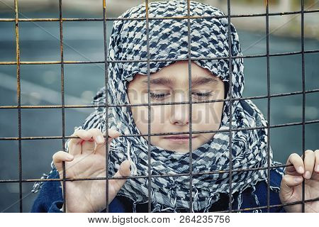 Crying Refugee Girl From The East In A Headscarf