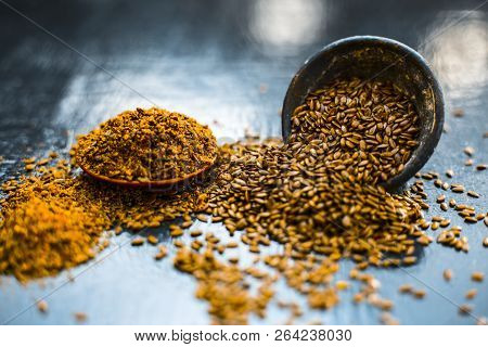 Close Up Of Ayurvedic Herb Alsi Or Adsi Or Flax Seed In A Black Colored Clay Bowl With Its Powder On
