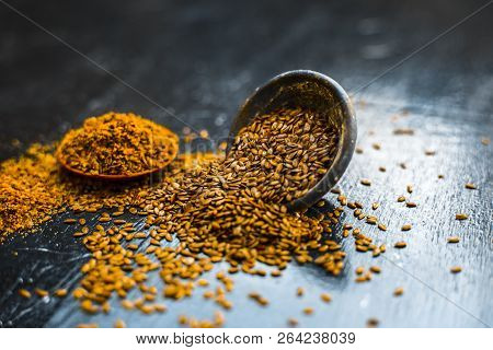 Close Up Of Ayurvedic Herb Alsi Or Adsi Or Flax Seed In A Black Colored Clay Bowl With Its Powder On