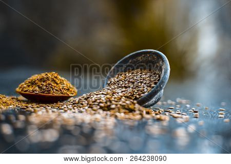 Close Up Of Ayurvedic Herb Alsi Or Adsi Or Flax Seed In A Black Colored Clay Bowl With Its Powder On