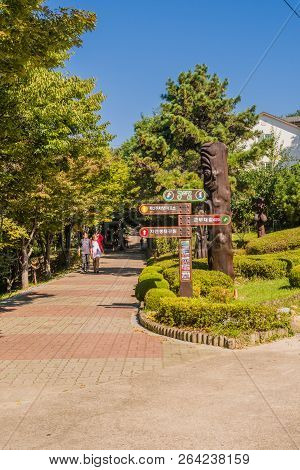 Samcheok, South Korea; September 25, 2018: Unidentified Asian Couple Walking On Brick Sidewalk As Th