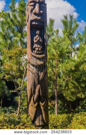 Samcheok, South Korea; September 25, 2018: Wooden Statue In Shape Of Human Penis With Young Woman In