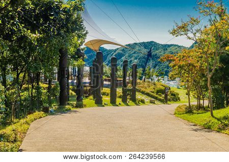 Samcheok, South Korea; September 25, 2018: Row Of Wooden Phallic Shaped Statues Erected Next To Conc