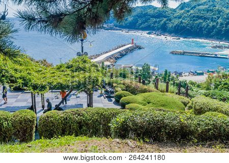 Samcheok, South Korea; September 25, 2018: Unidentified People Resting Under Vine Covered Awning Nex