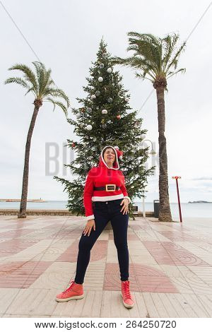 Christmas, Holidays And Humor Concept - Young Happy Woman Have Fun In Christmas Costume At Summer Ne