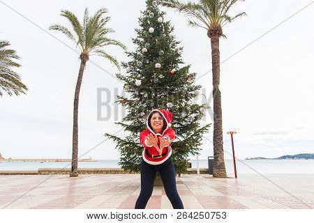 Christmas, Holidays And Humor Concept - Young Happy Woman Have Fun In Christmas Costume At Summer Ne