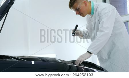 Professional Master After Polishing And Painting Cars, Checks The Flashlight Scratches, A Respirator