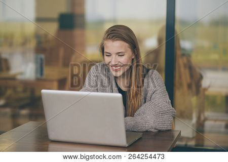 Successful Female Grapic Designer Watching Tutorial About Creative Ideas At Laptop Computer During W