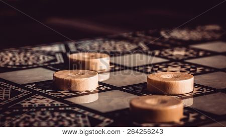 Playing Checkers Backgammon  On The Boardgames On The Wooden Bord