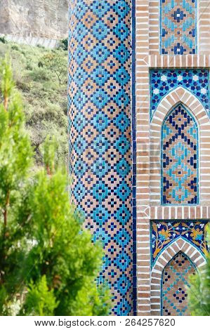 Colorful Mosaic Pattern Of Old Sulfur Baths In Old Town In Tbilisi Georgia. Green Tree Foreground.