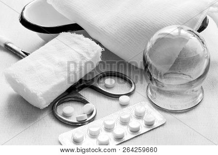Retro. Glass Medical Jar, Steel Surgical Clamp, Bandage, Pills, Gauze Cloth, Metal Patch On A White 