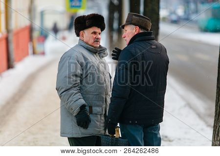 Minsk, Belarus - January 14, 2013: Two Old Men Having Serious Coversation In Winter Street