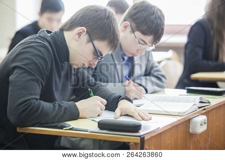 Minsk, Belarus - February 20, 2013: Teenage Boys Making Notes In Their Exercisebooks At The Lesson O