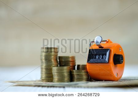 Tally Counter Or Counting Machine With 0000 Number, Coin And Banknote On White Wooden Table, Busines