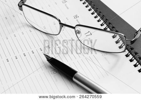 Business. Retro. Plan For The Week. Glasses In A Metal Frame And Pen With An Open Gold Pen On The Or
